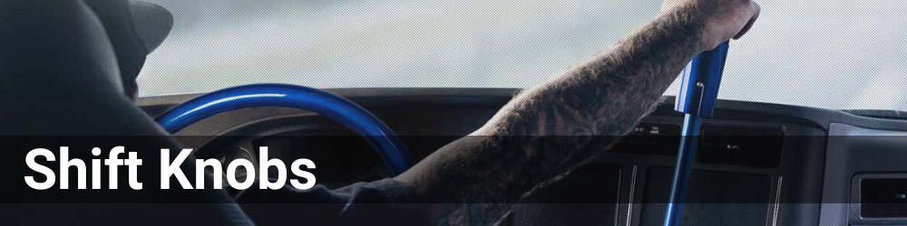 A trucker is in the drivers seat and holding onto a shift knob. The header is Shift Knobs in a white font.